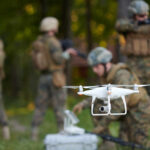 A military drone being prepared for use with soldiers in the background