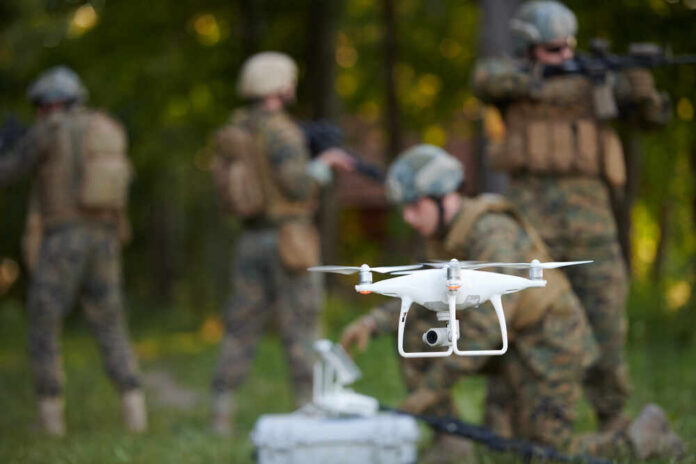 A military drone being prepared for use with soldiers in the background