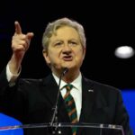 Kennedy’s Bold Move: SAVE Act Showdown A speaker passionately addressing an audience at a conference