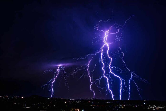 shutterstock_2466567631.jpg Multiple lightning strikes illuminating a dark night sky