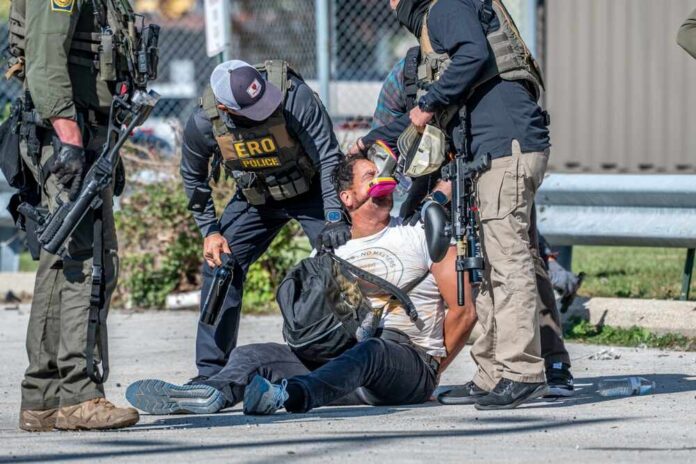 shutterstock_2683835947.jpg Law enforcement officers apprehending a suspect on the ground