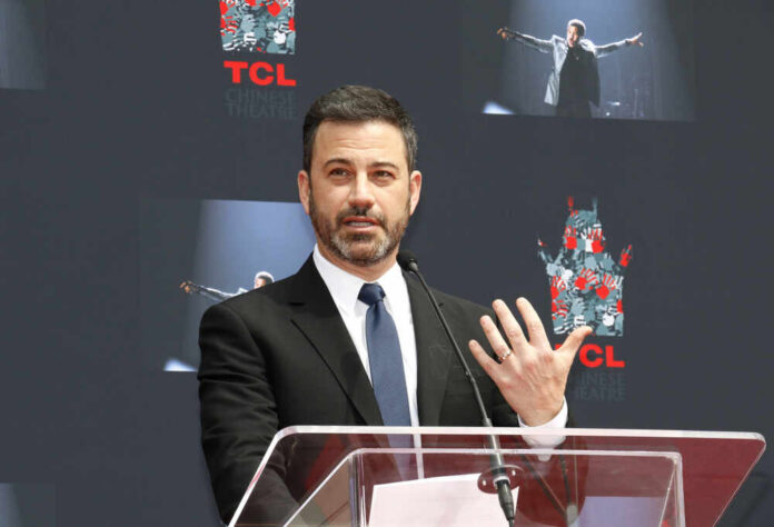 shutterstock_1040900056.jpg A man in a suit speaking at a podium during an event at TCL Chinese Theatre