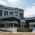 Fraud Scandal Erupts: SPLC’s Secret Payments Modern building with a large banner displaying a historical quote