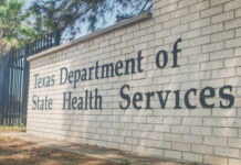 Sign for the Texas Department of State Health Services on a brick wall