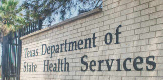 Sign for the Texas Department of State Health Services on a brick wall