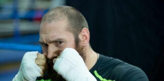 Boxer in training with hands wrapped, preparing for a fight