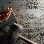 Ritual Redefined: Less Pain, Same Faith An artificial hand with a nail embedded and blood effects on a textured surface