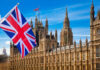 British flag waving in front of the Parliament building in London