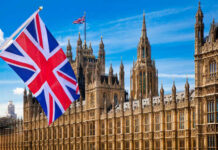 British flag waving in front of the Parliament building in London
