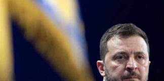 Person with short hair next to blurred yellow flag