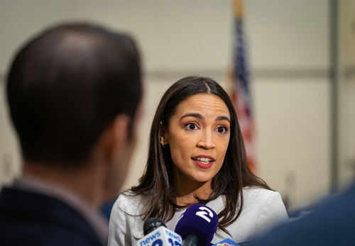 alexandria-ocasio-cortez-aoc2252440791jpg Person speaking to reporters with microphones indoors