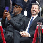 Media’s OUTRAGEOUS Bias: Tapper’s Kimmel Defense Two men sitting together at a celebrity event, one taking a photo