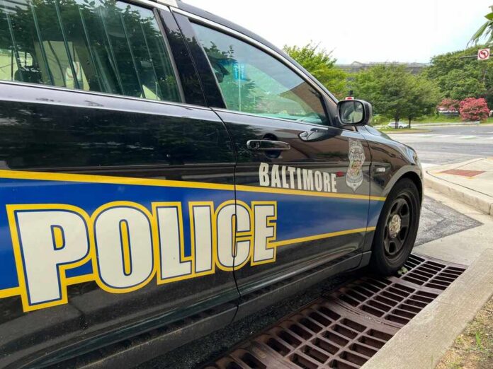 shutterstock_2339490737.jpg Side view of a Baltimore police car parked on a street