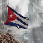 Invasion Chatter Spikes — Proof Still Missing Worn Cuban flag standing on rubble in a desolate urban environment