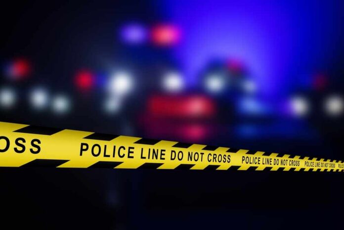 shutterstock_2754098255.jpg Yellow police tape reading 'DO NOT CROSS' at a crime scene