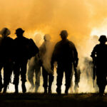 Massive Russian Losses? What’s the Real Story? Silhouettes of soldiers walking through smoke at sunset
