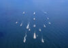 Aerial view of multiple naval ships operating in the ocean