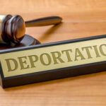 The $100 Million Case That Vanished Gavel and sign reading Deportation on desk.