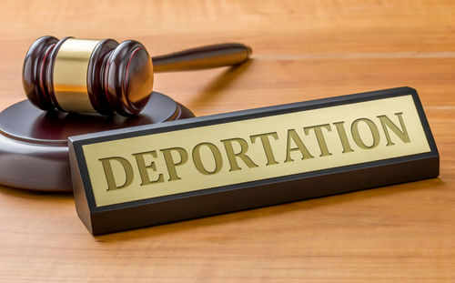 deportation575161729 Gavel and sign reading Deportation on desk.