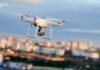 Drone flying above a cityscape.