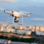 Drone flying above a cityscape.