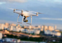 Drone flying above a cityscape.