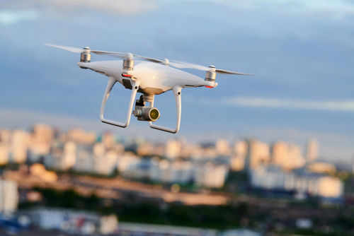 drone1780283180 Drone flying above a cityscape.