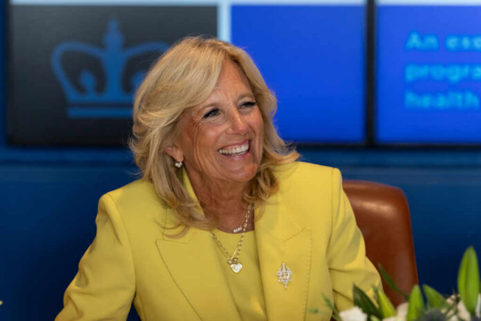 jill-biden2330921017jpg Smiling woman in a yellow blazer at a meeting table