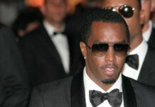 Man wearing tuxedo and sunglasses at formal event