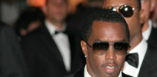 Man wearing tuxedo and sunglasses at formal event