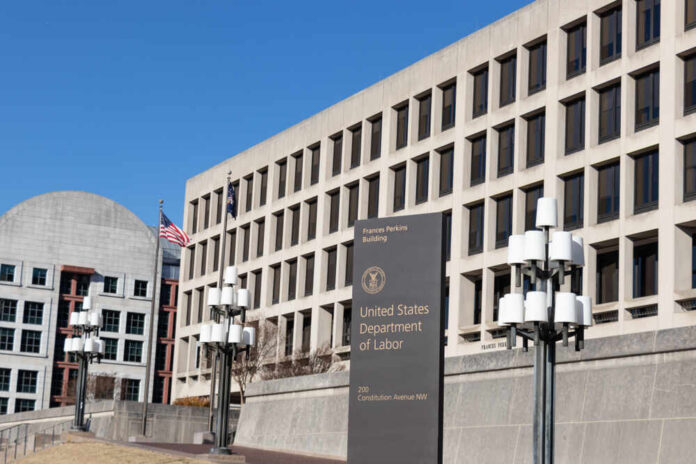 Washington,,Dc,,Usa,-,December,11,,2019:,Sign,On,Constitution Exterior view of the United States Department of Labor building with flags
