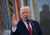 Anti-Weaponization Fund—DOA Or Dark Pause? A man speaking passionately into a microphone with his hand raised