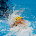 Viral Clip Twists Storm, Code Violations Swimmer in yellow cap racing in pool