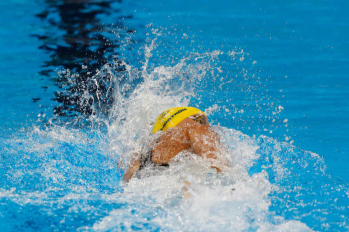 swimming-competition1843670269jpg Swimmer in yellow cap racing in pool