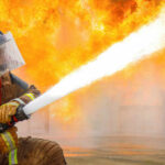 Brooklyn Church Inferno Sparks Arson Investigation Firefighter spraying water to extinguish large blaze