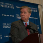 Washington Faces A Sudden Republican Turning Point Man in suit speaking at a podium with a microphone