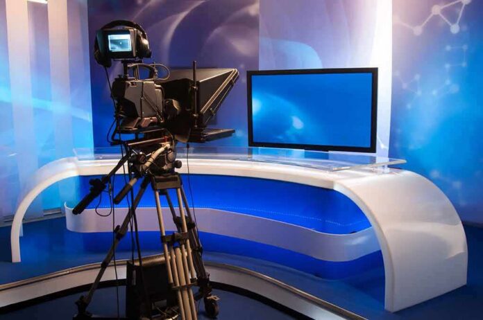 Television studio with camera and news desk