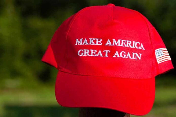 Red baseball cap with political slogan and small U.S. flag patch