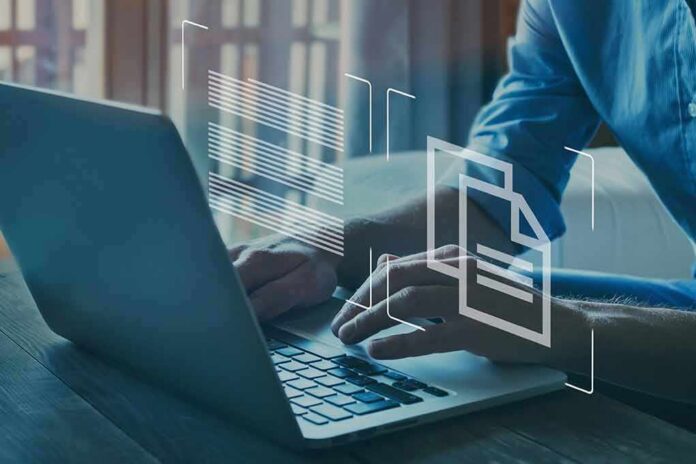 hands typing on a laptop with digital document icons