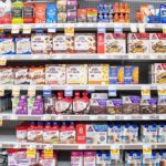 Grocery aisle shelves with protein bars and shakes