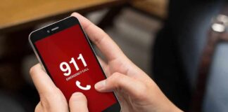 Hands holding a smartphone with a 911 emergency call screen