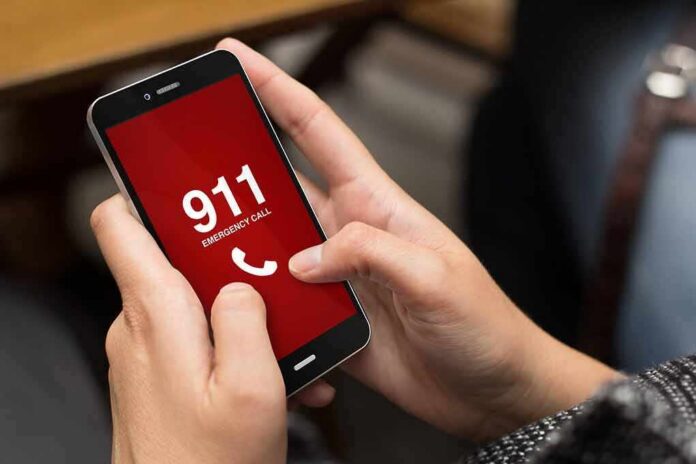 shutterstock_327355202 Hands holding a smartphone with a 911 emergency call screen